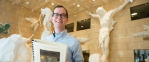 Member Nick Hartigan standing in a museum