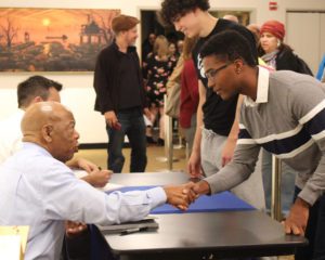 Two men shaking hands during Vermont Reads signing