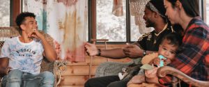 Young man talking to family with young baby